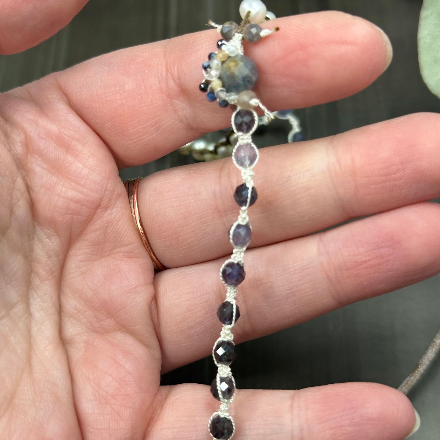 Incredibly intricate knotted and strung wrap piece with moonstone, iolite, sapphire, pearl, and more
