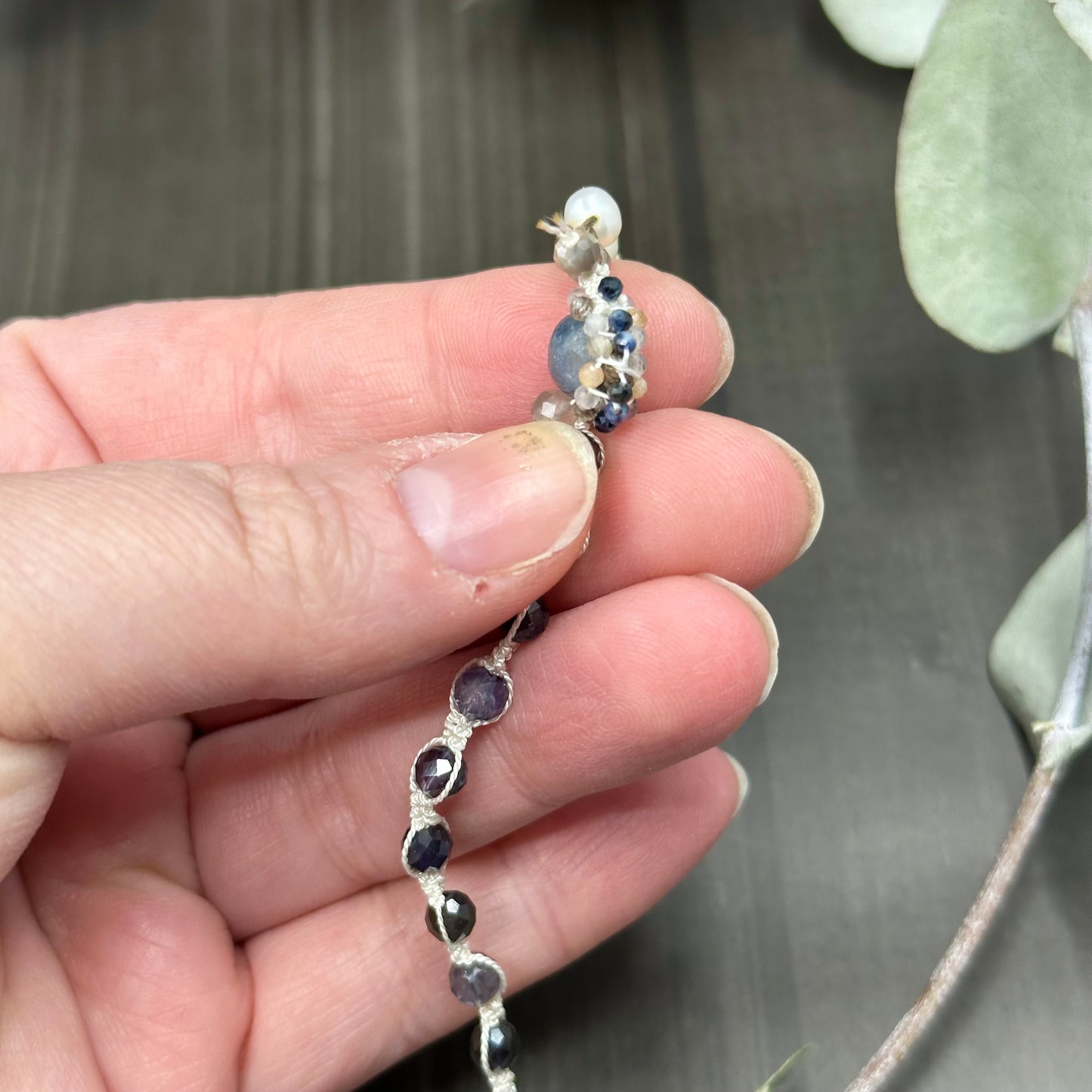 Incredibly intricate knotted and strung wrap piece with moonstone, iolite, sapphire, pearl, and more