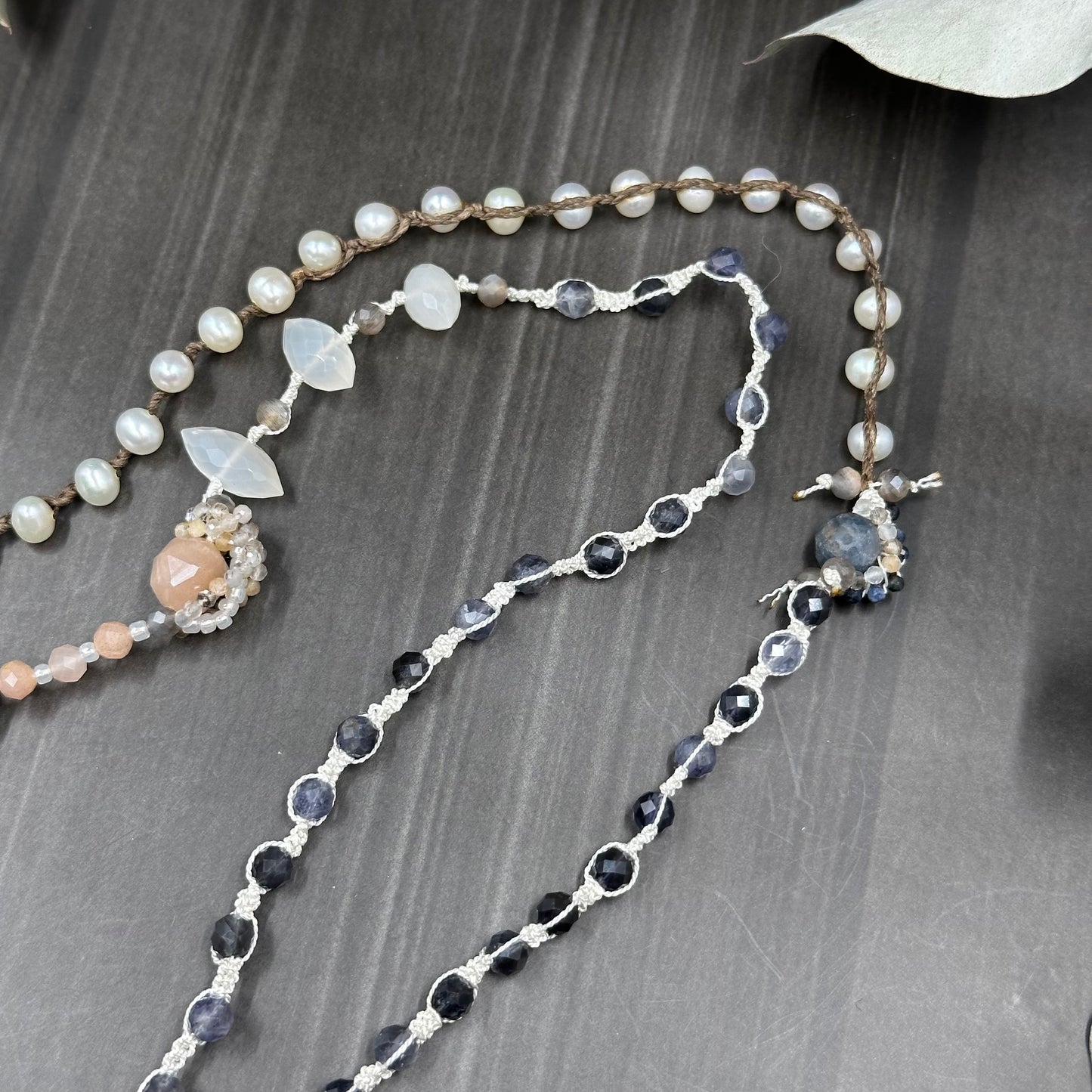 Incredibly intricate knotted and strung wrap piece with moonstone, iolite, sapphire, pearl, and more