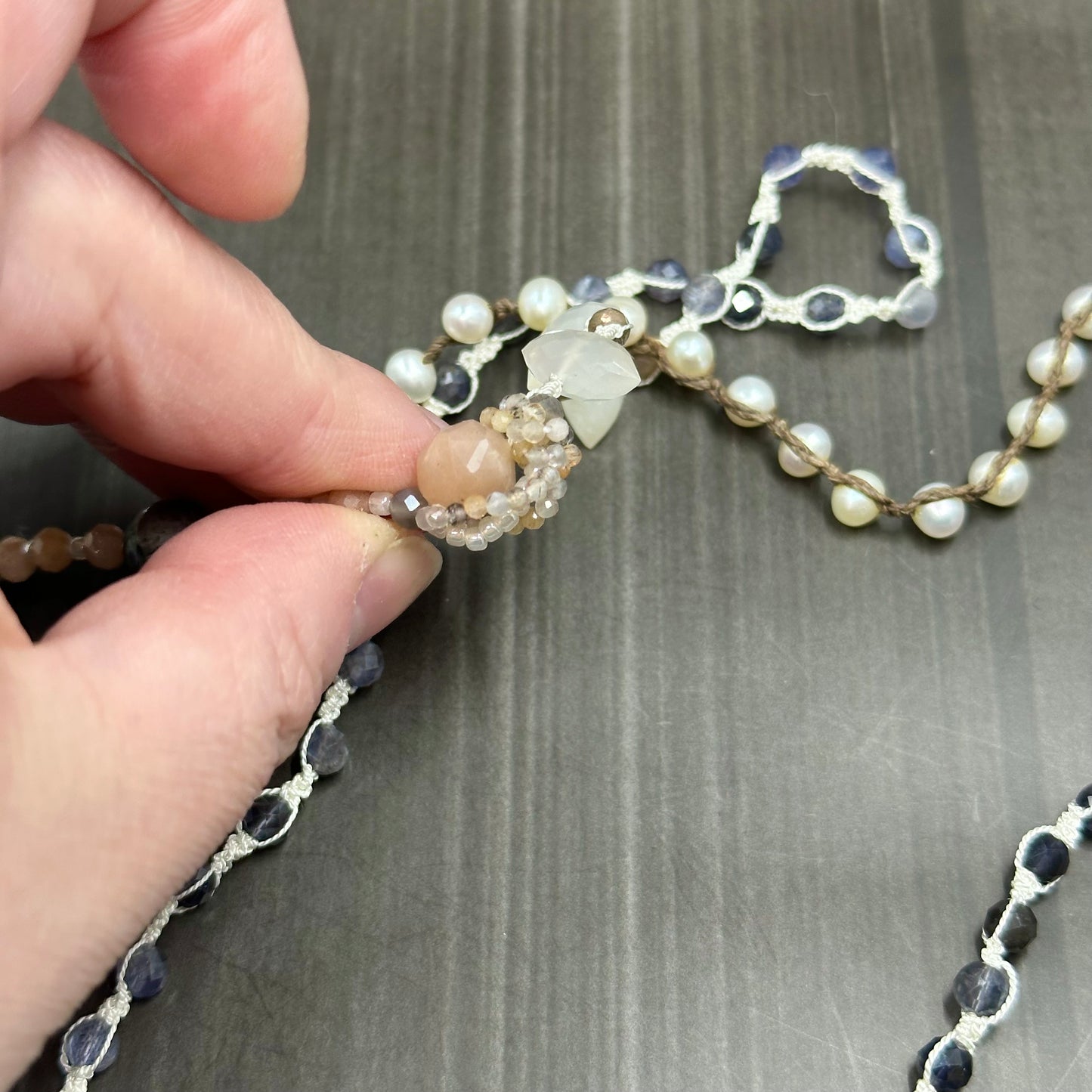 Incredibly intricate knotted and strung wrap piece with moonstone, iolite, sapphire, pearl, and more